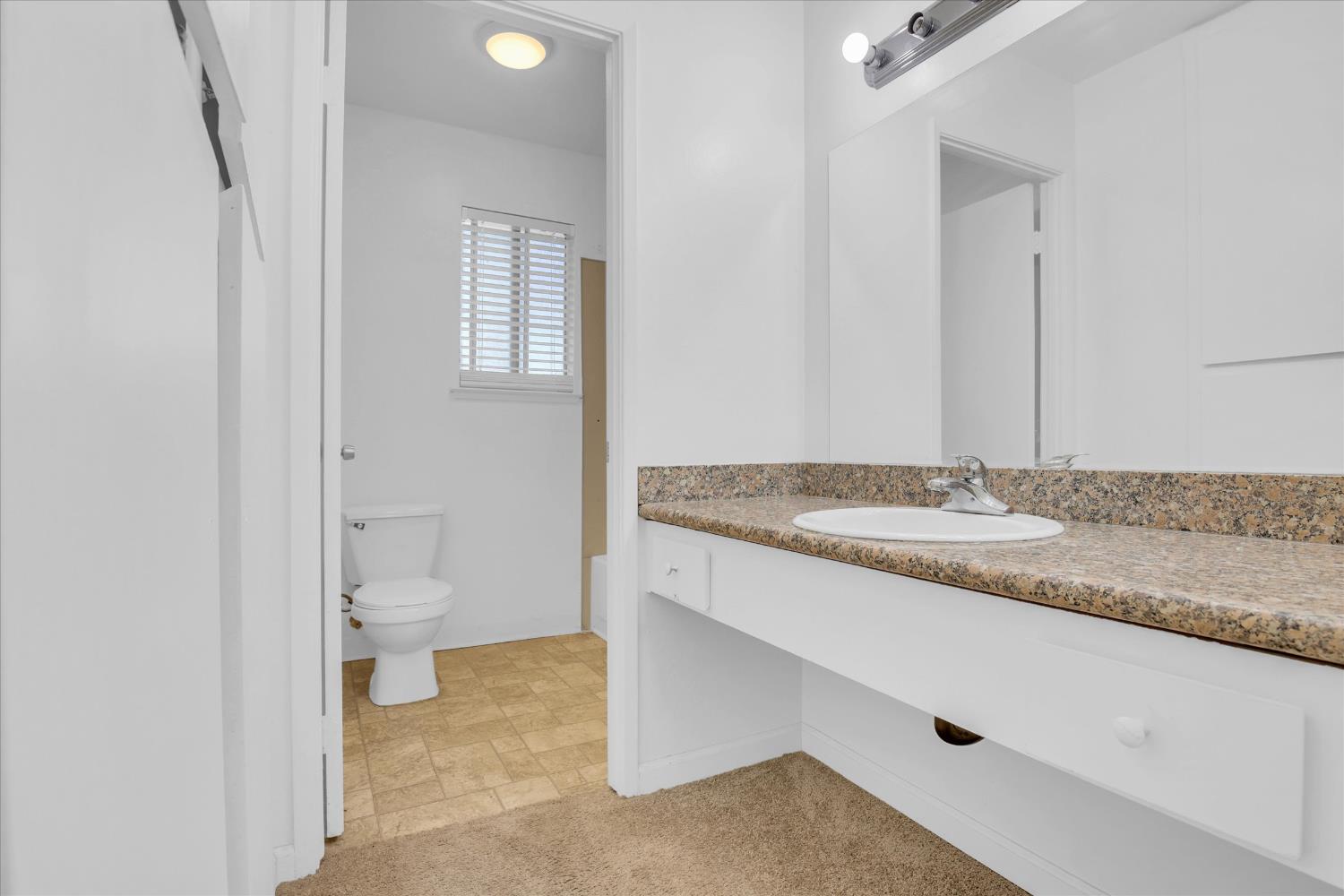 2200 Kimwood Lane Rancho Cordova, CA 95670 - Photo 17 of 26 a bathroom with a granite countertop sink and a toilet