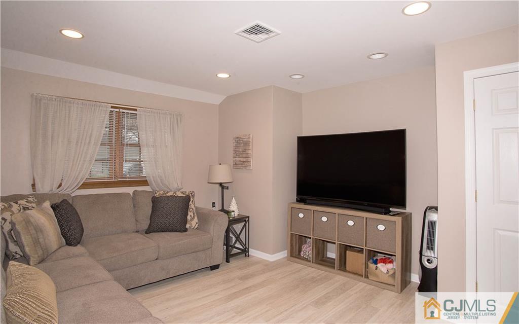 52 Idlewild Road Edison, NJ 08817 - Photo 6 of 21 a living room with furniture and a flat screen tv