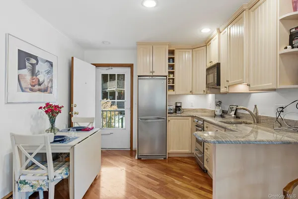 a kitchen with a refrigerator stove top oven and sink
