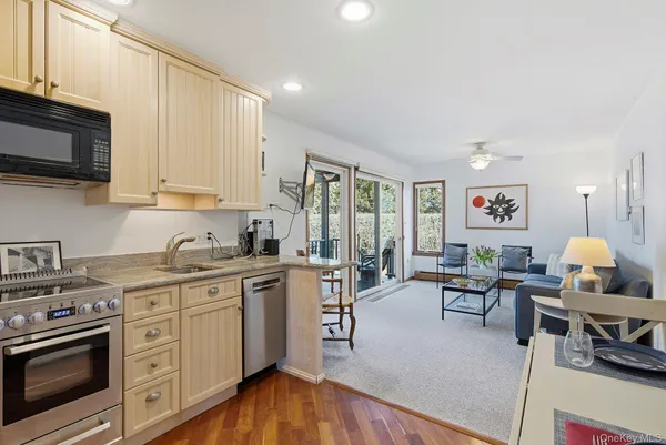 a kitchen with stainless steel appliances granite countertop a stove and white cabinets