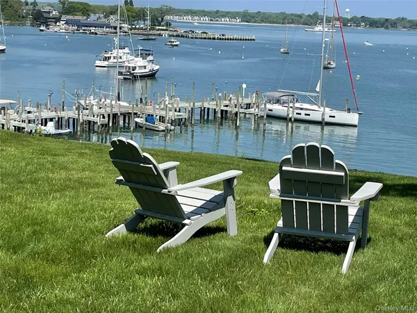 a front view of a house with a yard and lake view