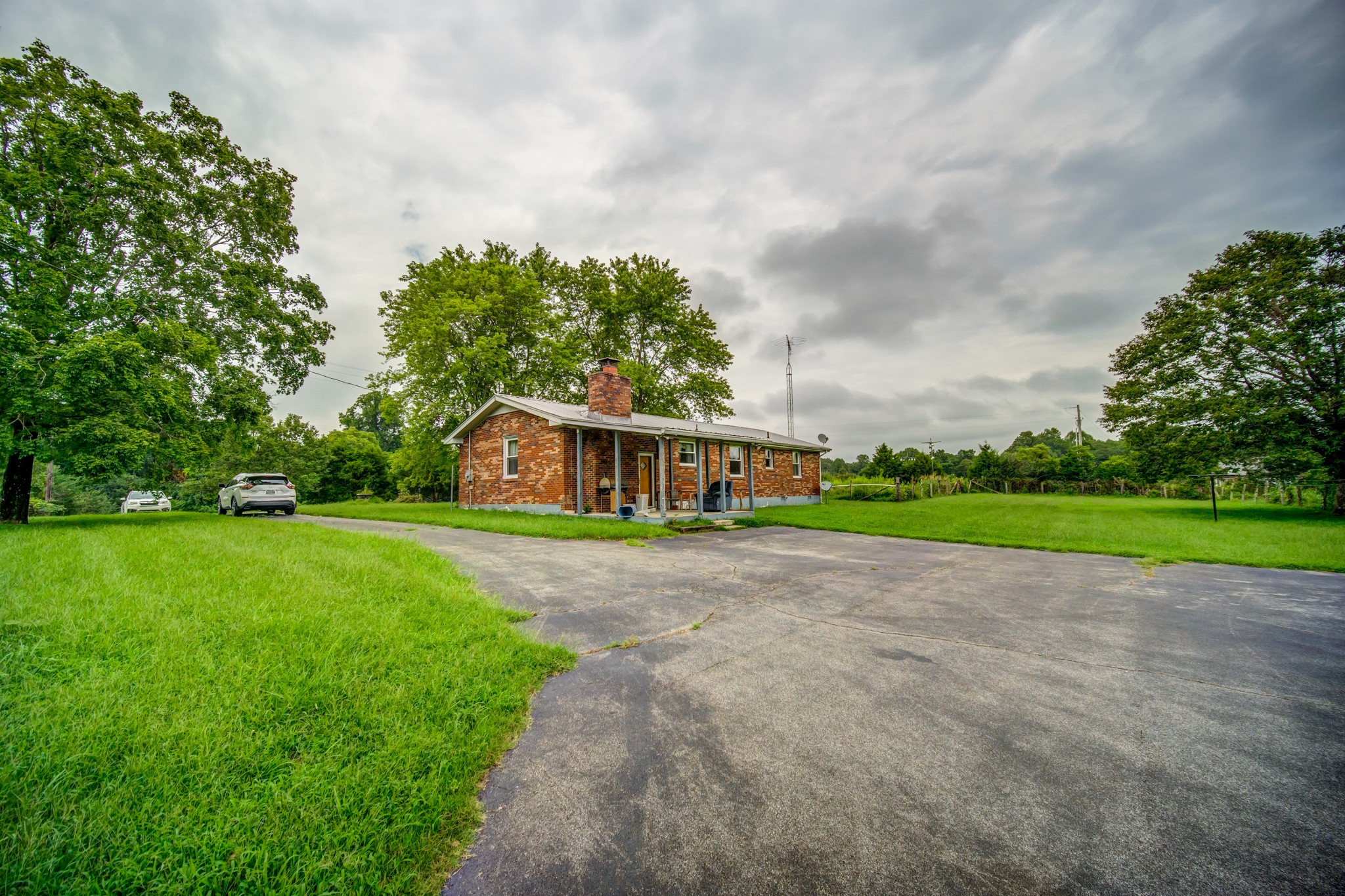 1377 Deal Road Burns, TN 37029 - Photo 39 of 47 a view of a house with a big yard and large trees