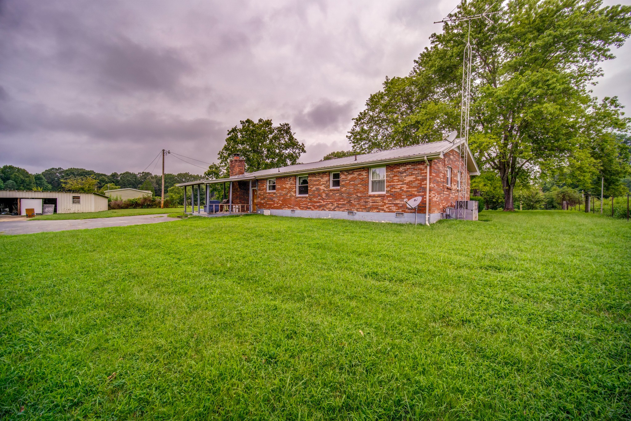 1377 Deal Road Burns, TN 37029 - Photo 42 of 47 a view of a house with a big yard and large trees
