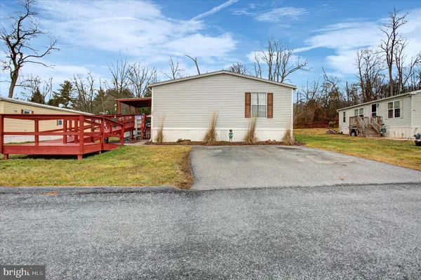 a view of a house with a yard and garage