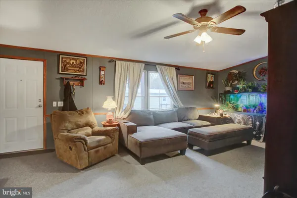 a living room with patio furniture and a large window
