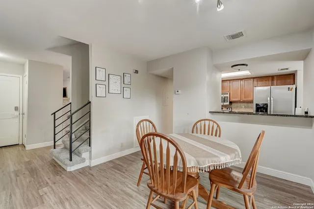 a view of a a dining room with furniture window and wooden floor