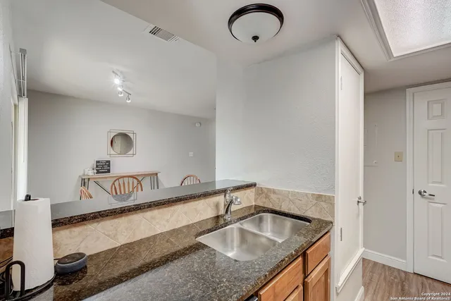 a kitchen with sink and refrigerator