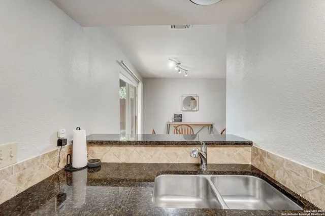 a bathroom with a sink and mirror