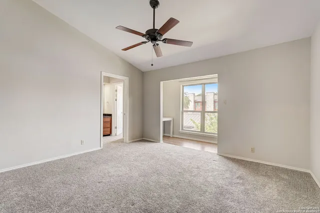 a view of a livingroom with a ceiling fan and window