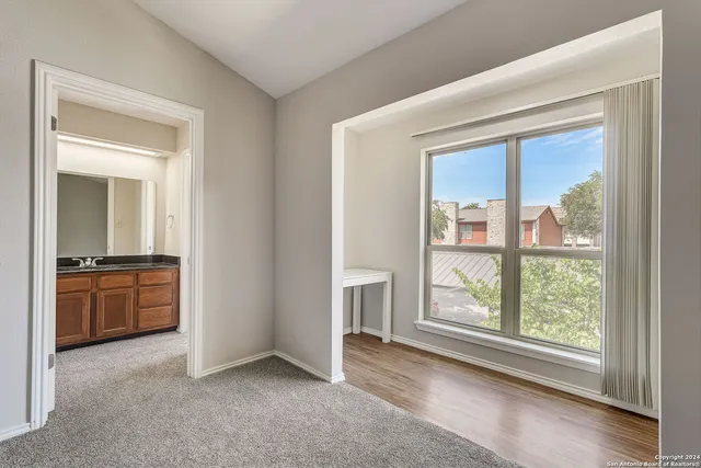 a view of an empty room with a kitchen