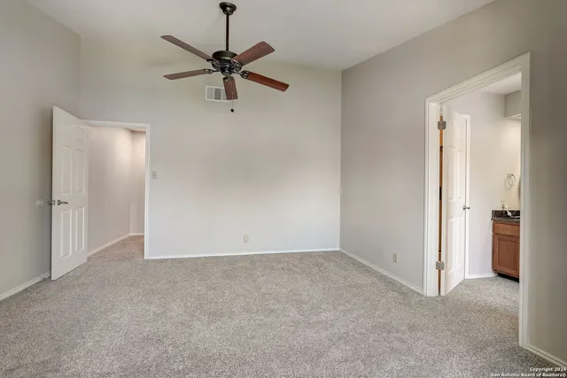 a view of an empty room with a fan