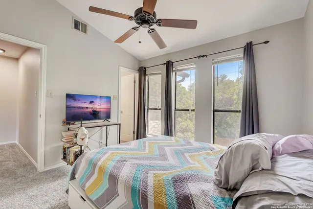 a bedroom with a bed and a flat tv screen