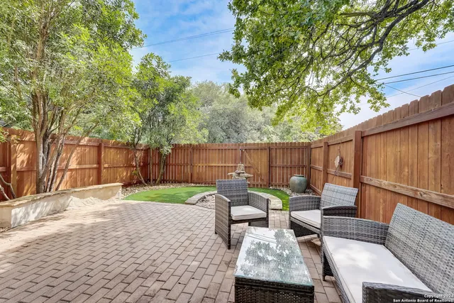 a view of a patio with chairs and a table