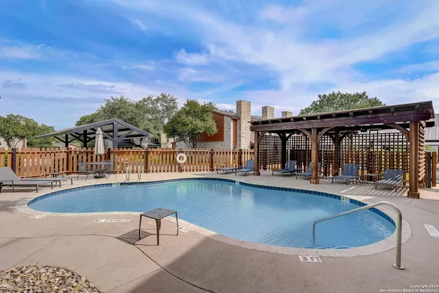 a view of a swimming pool with a lounge chair