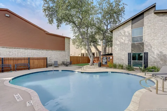 a view of a patio with swimming pool table and chairs