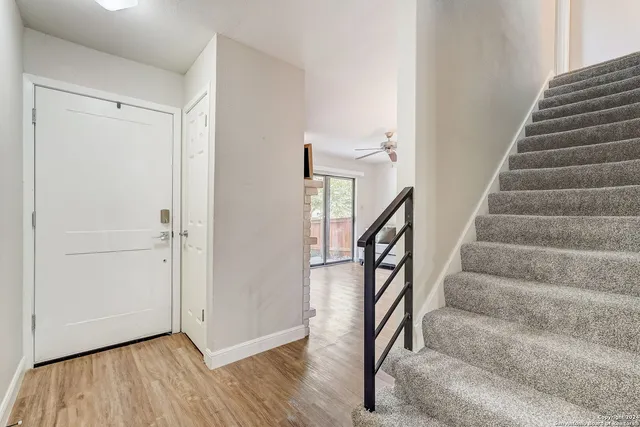 a view of entryway with wooden floor and stairs
