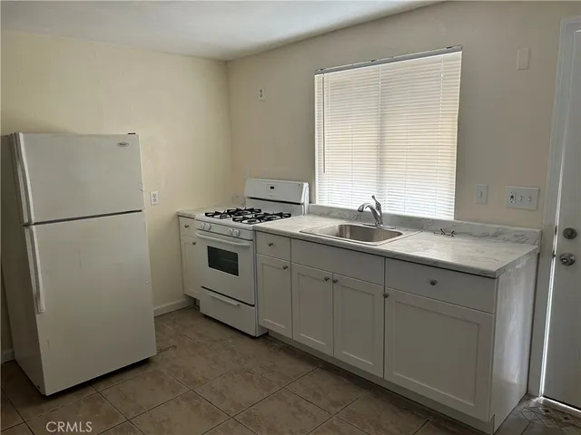a kitchen with a sink and a refrigerator