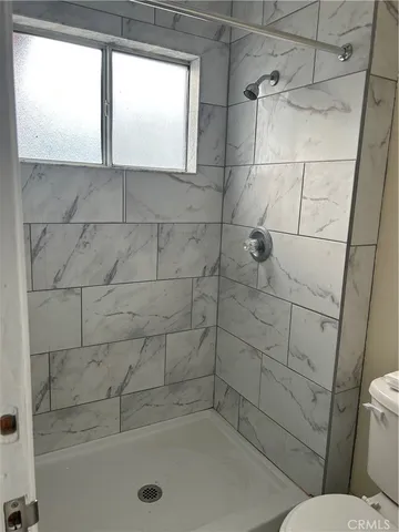 a bathroom with a window and a shower