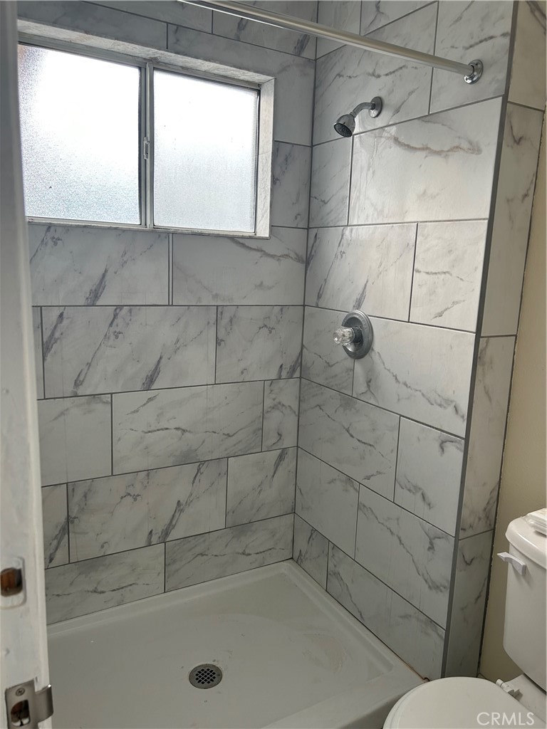 632 North Birch Avenue, Unit B Rialto, CA 92376 - Photo 6 of 8 a bathroom with a window and a shower