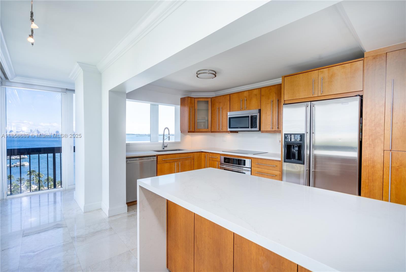 2333 Brickell Avenue, Unit 1511 Miami, FL 33129 - Photo 3 of 28 a kitchen with stainless steel appliances a refrigerator a sink a stove and island