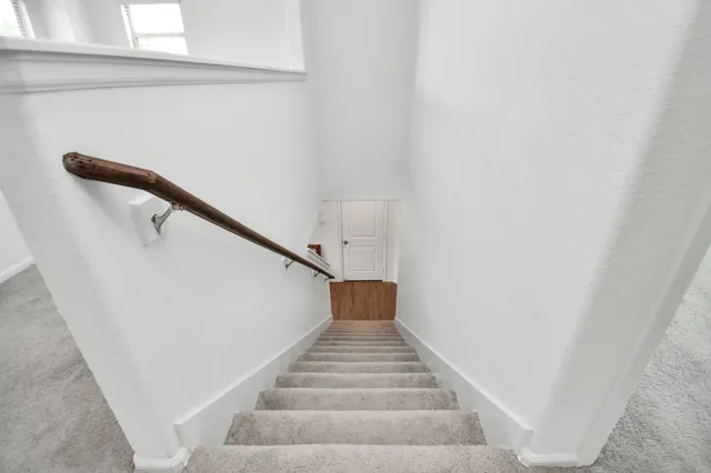 a room with window and a dresser