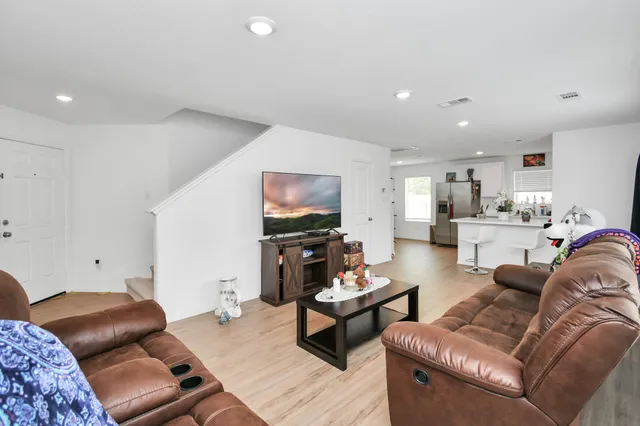 a kitchen with stainless steel appliances a refrigerator and a stove top oven
