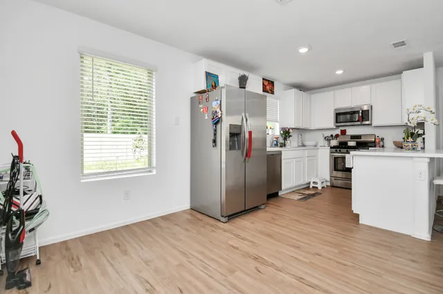 a view of a dining room with furniture and wooden floor