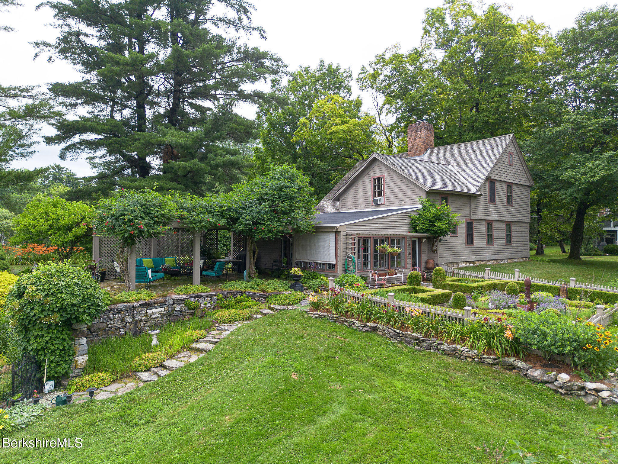 18 Goodrich Street Stockbridge, MA 01262 - Photo 11 of 63 a front view of a house with a garden