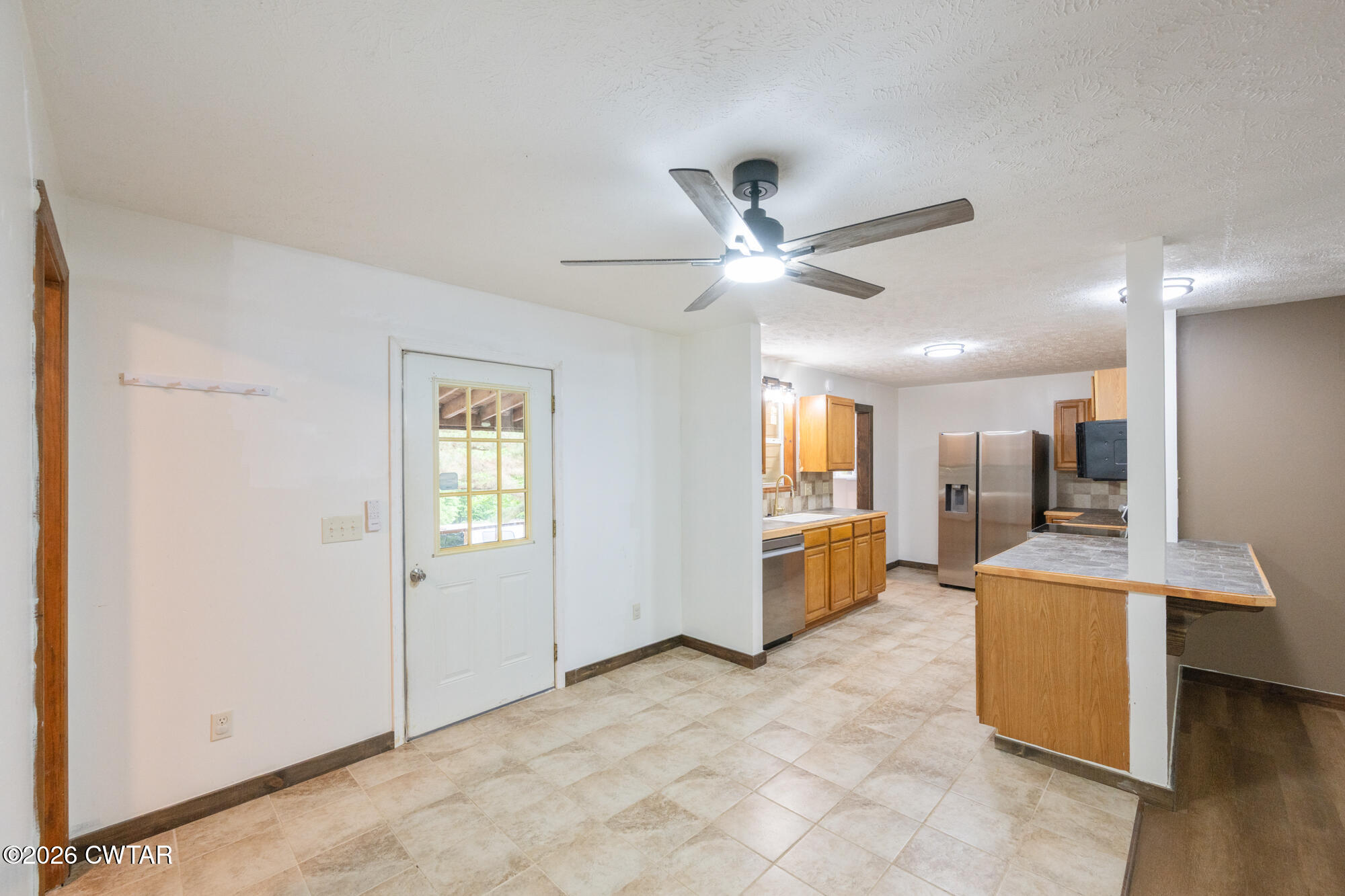 2827 Chapel Hill Road McKenzie, TN 38201 - Photo 13 of 40 a view of a big room with chandelier fan and windows