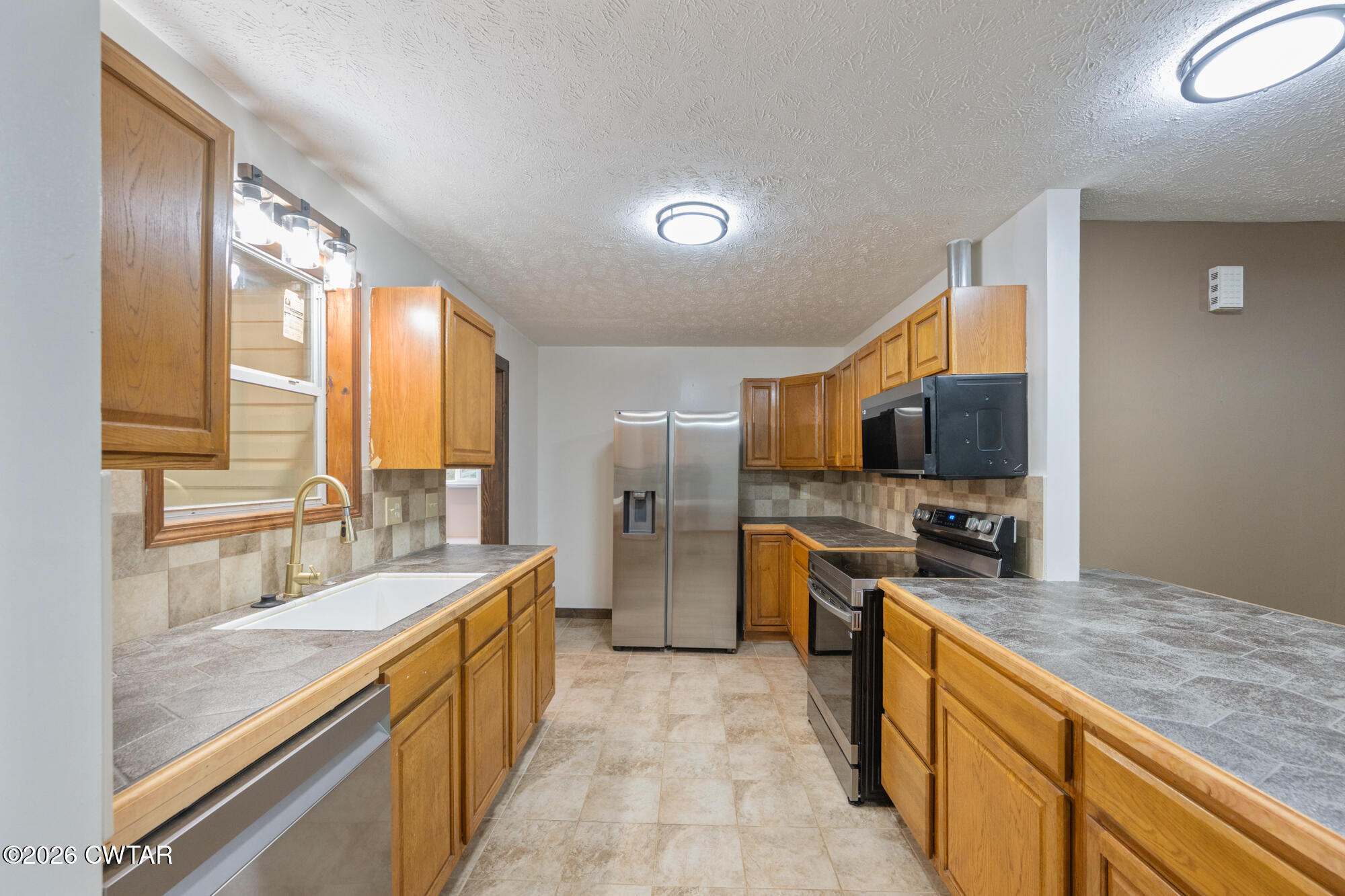 2827 Chapel Hill Road McKenzie, TN 38201 - Photo 15 of 40 a large kitchen with a large window and stainless steel appliances
