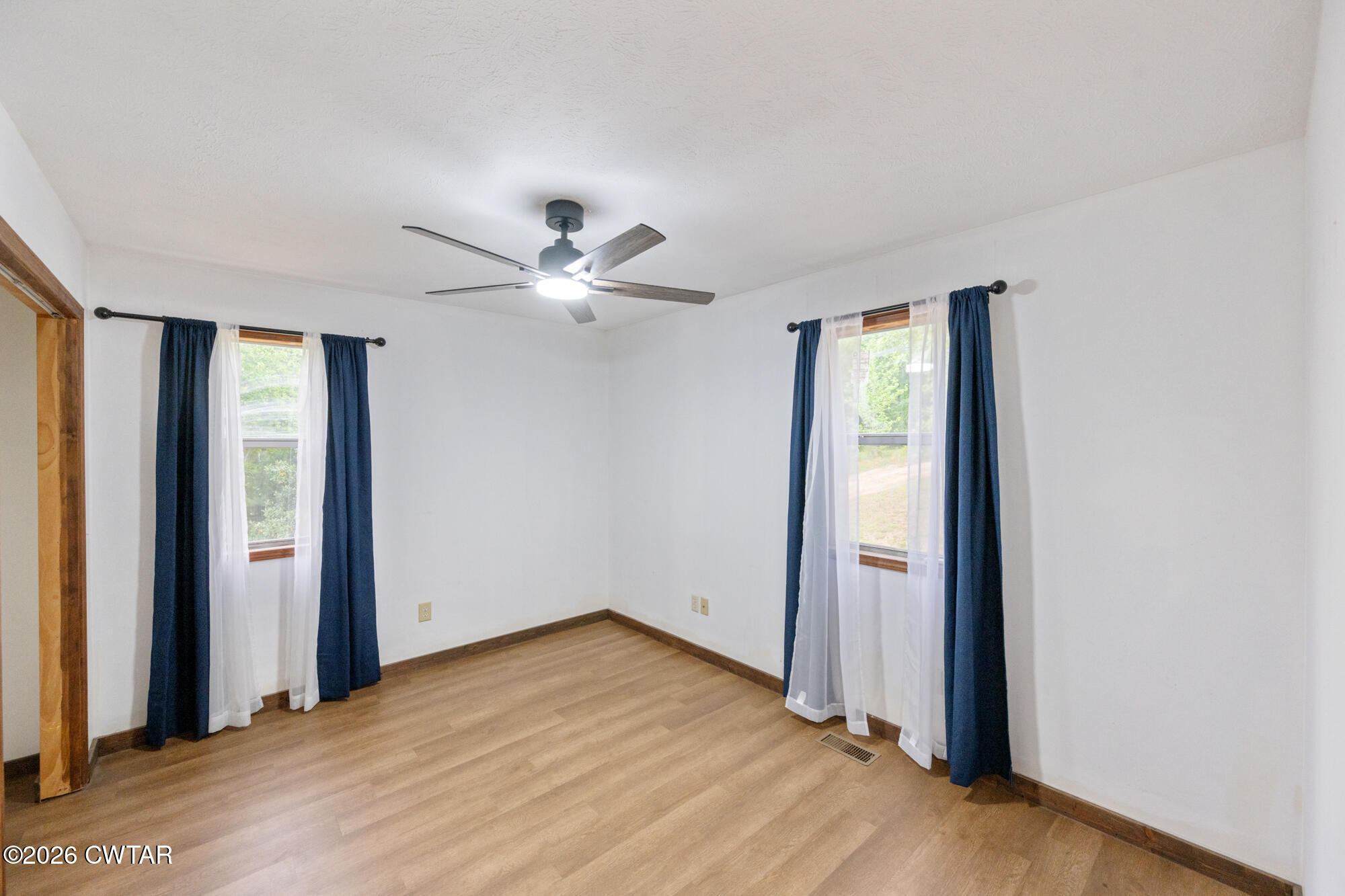 2827 Chapel Hill Road McKenzie, TN 38201 - Photo 18 of 40 an empty room with wooden floor closet and windows