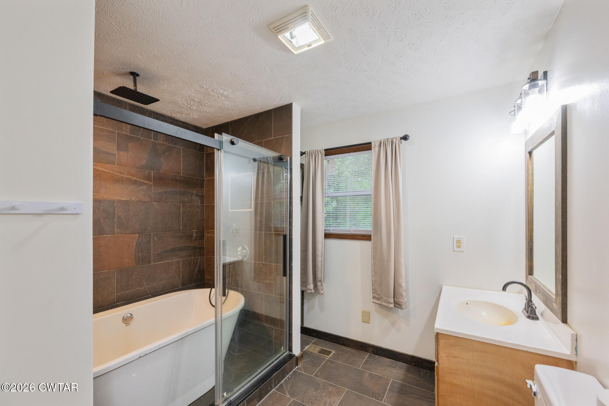2827 Chapel Hill Road McKenzie, TN 38201 - Photo 23 of 40 a bathroom with a tub shower and sink