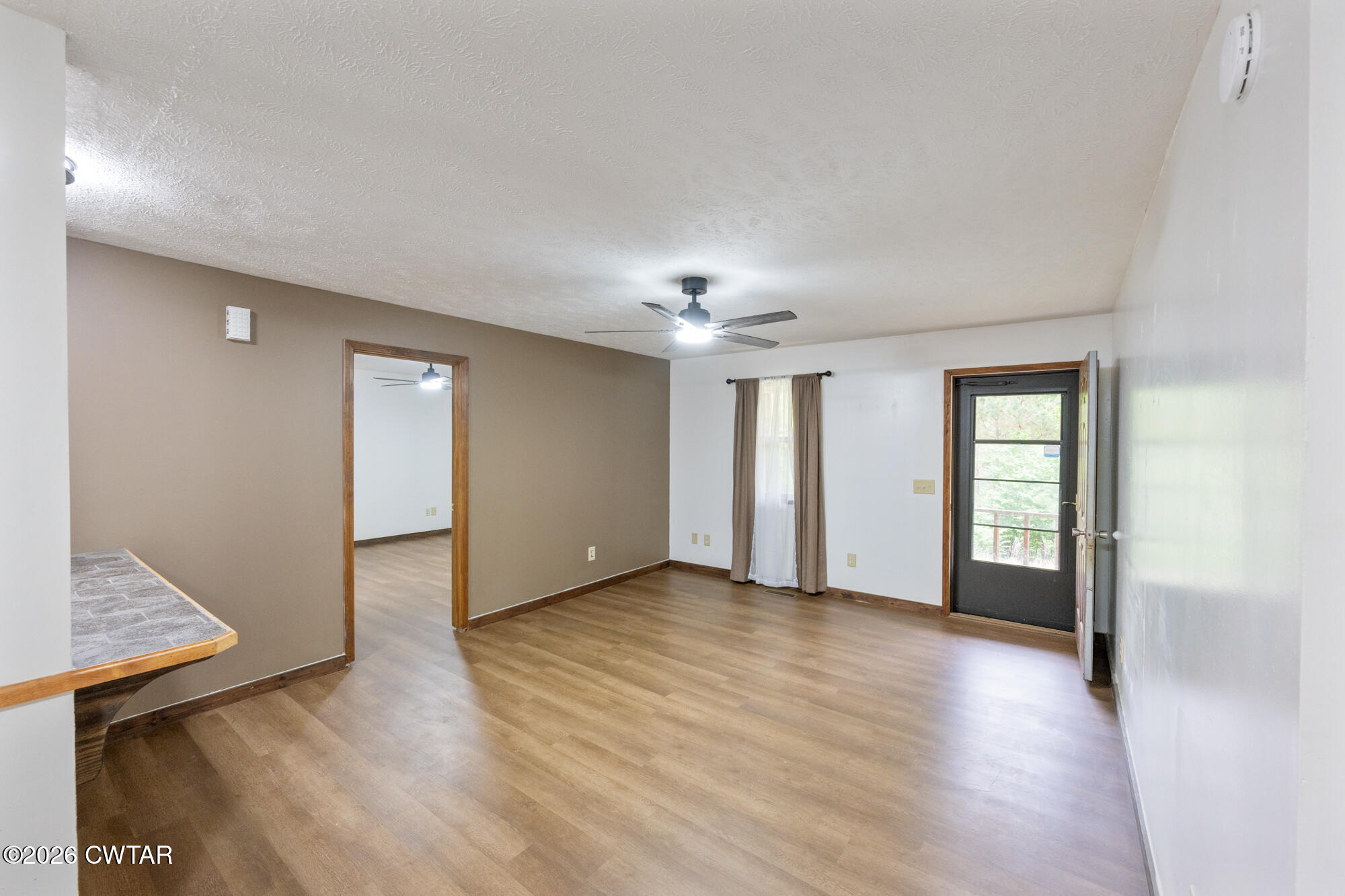 2827 Chapel Hill Road McKenzie, TN 38201 - Photo 10 of 40 a view of an empty room with window and wooden floor