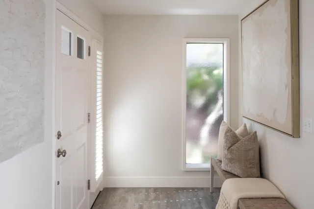 a white bath tub sitting next to a white cabinet