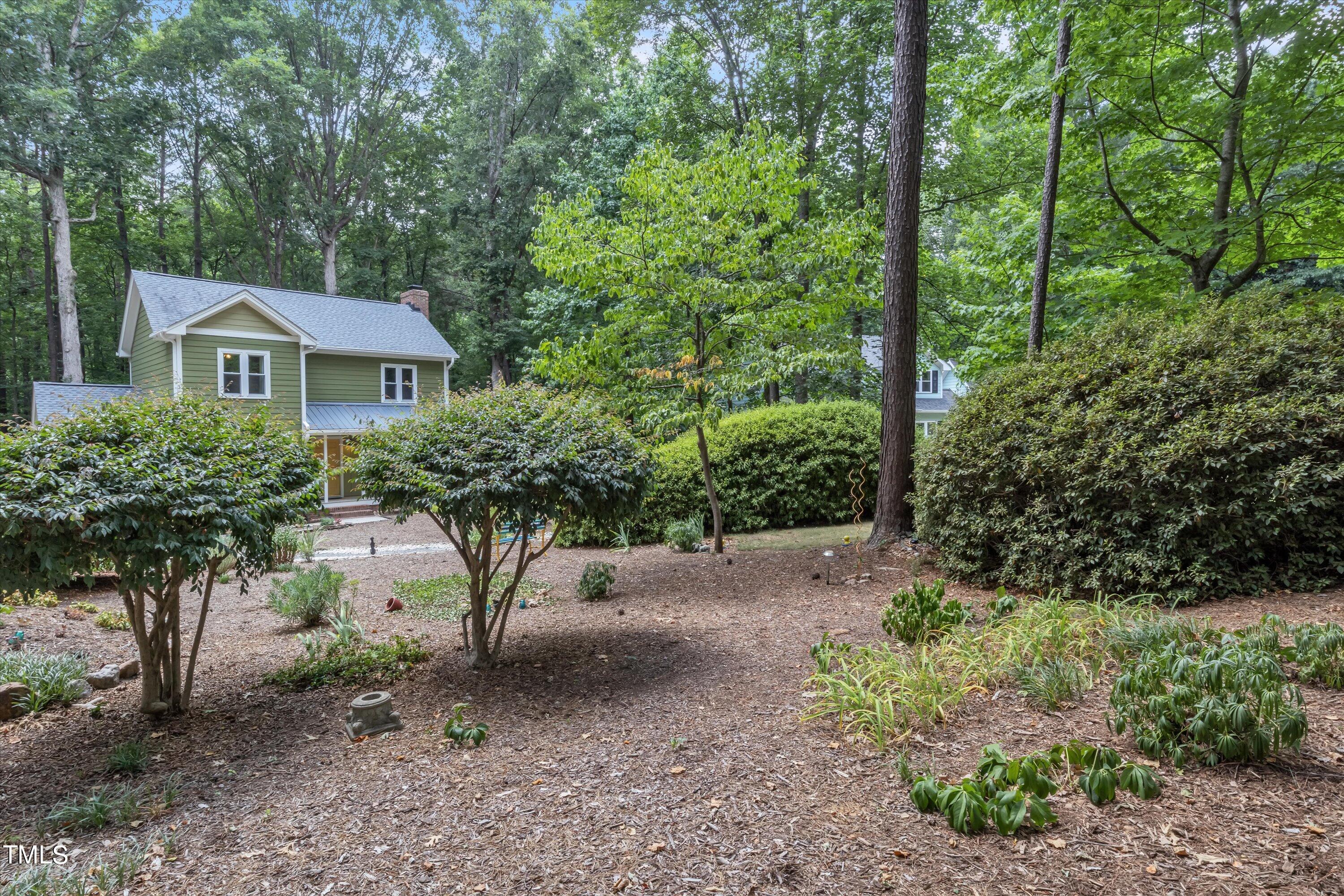 9208 Tree Meadow Lane Raleigh, NC 27603 - Photo 46 of 61 a view of a tree in front of a house with large trees