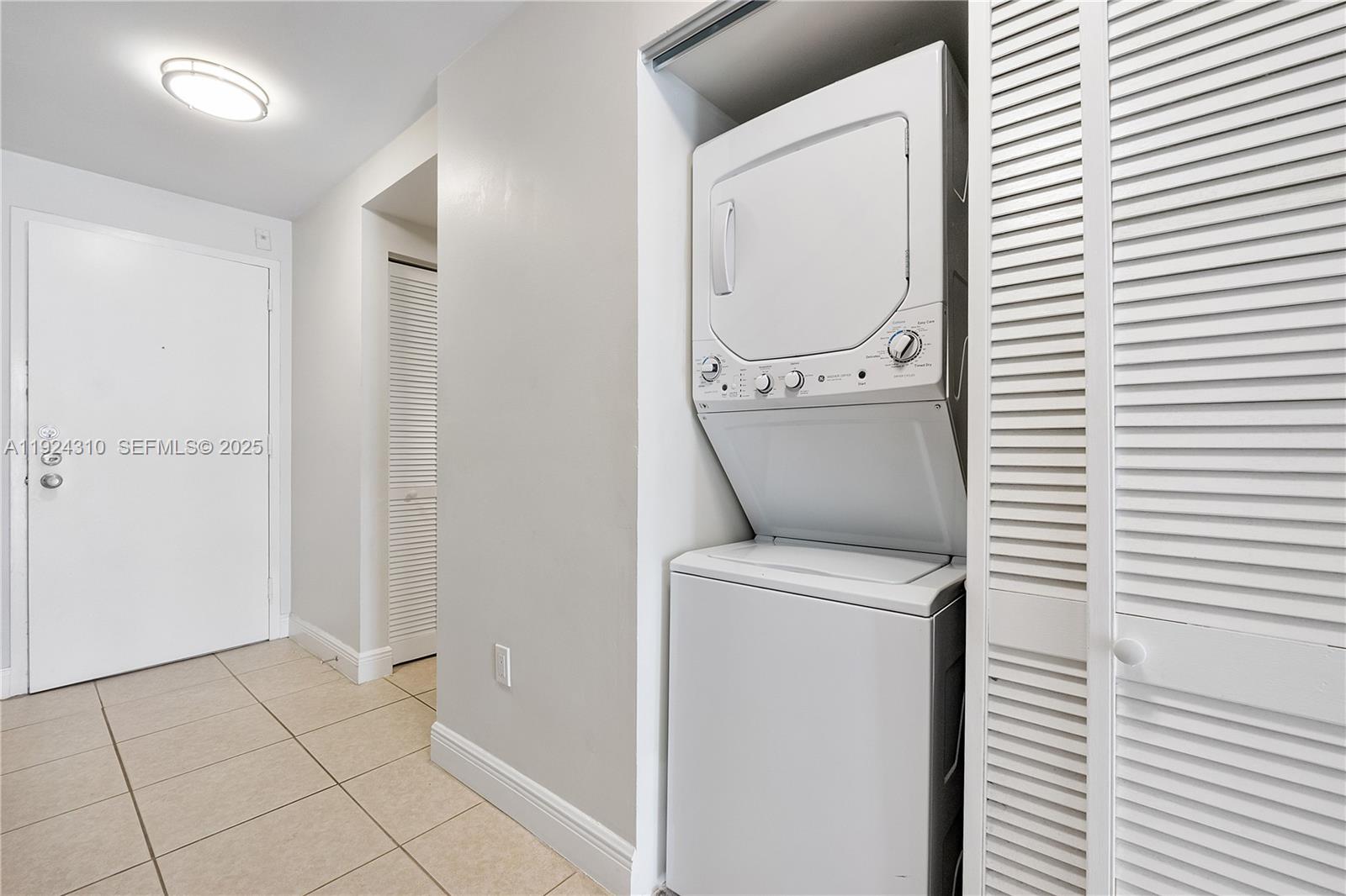 2977 McFarlane Road, Unit 9 Miami, FL 33133 - Photo 26 of 41 a view of a storage & utility room with a washer and dryer