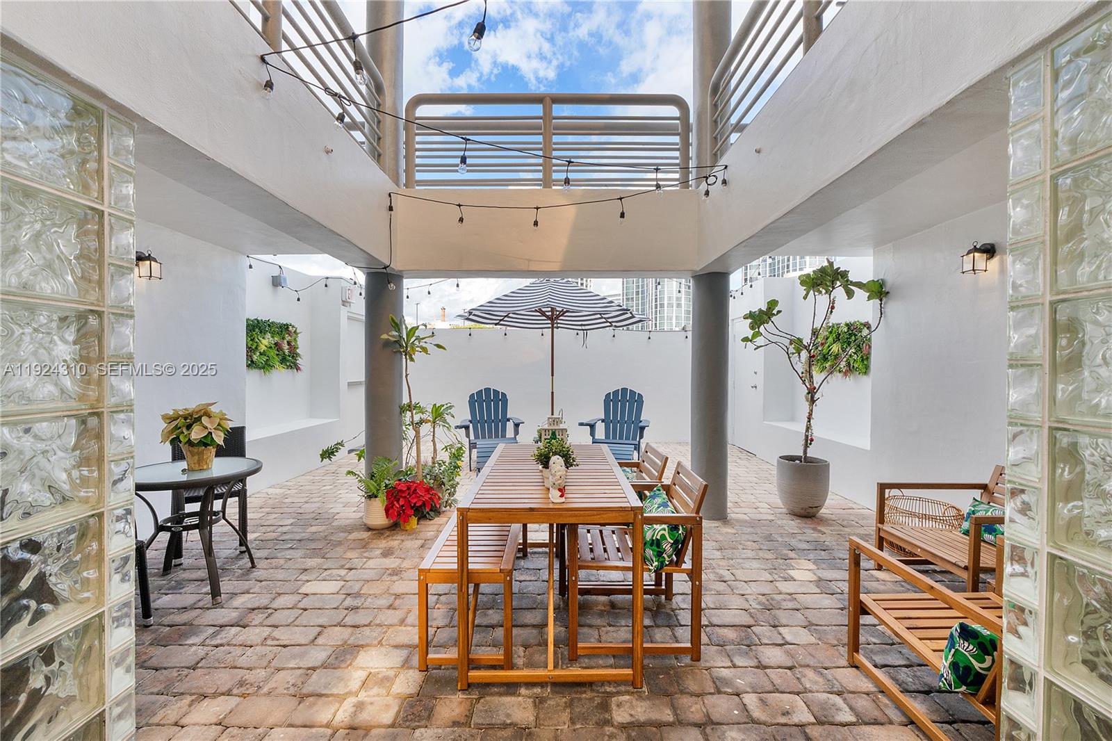 2977 McFarlane Road, Unit 9 Miami, FL 33133 - Photo 33 of 41 a dining room with furniture a rug and a chandelier