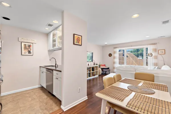 a kitchen with stainless steel appliances granite countertop a sink and a stove with wooden floor