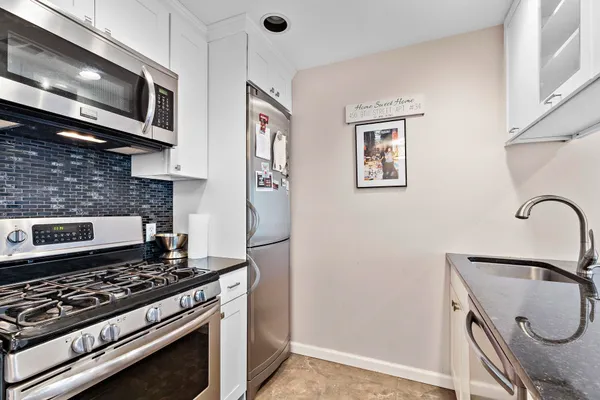 a kitchen with stainless steel appliances granite countertop a sink and a cabinets