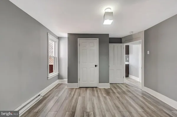 a view of room with window and hardwood floor