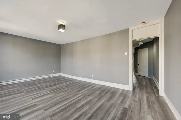 a view of an empty room with wooden floor