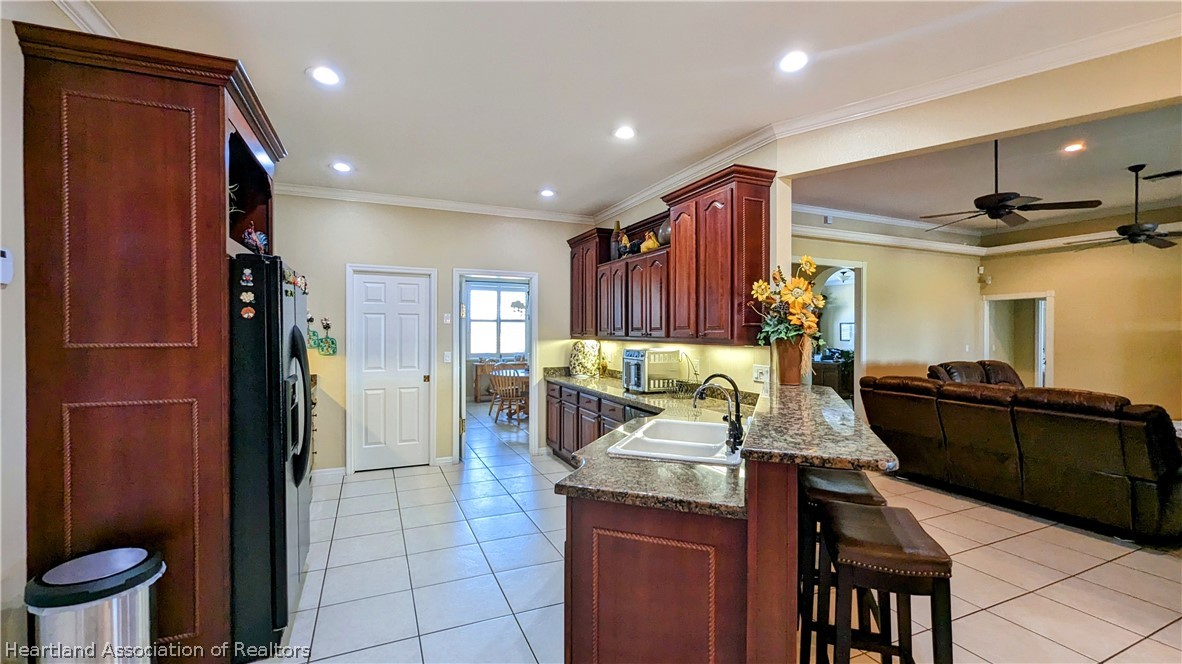 2120 Jack Smith Road Zolfo Springs, FL 33890 - Photo 14 of 36 a dining hall with stainless steel appliances granite countertop a refrigerator and a stove top oven