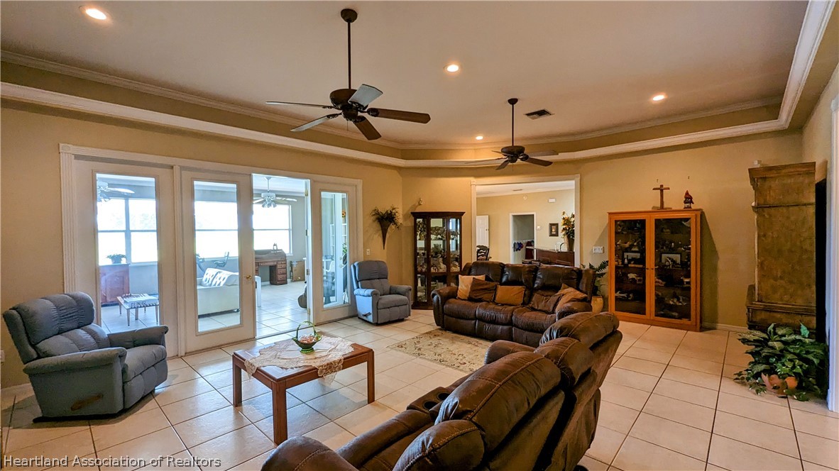 2120 Jack Smith Road Zolfo Springs, FL 33890 - Photo 18 of 36 a living room with furniture a chandelier and a flat screen tv