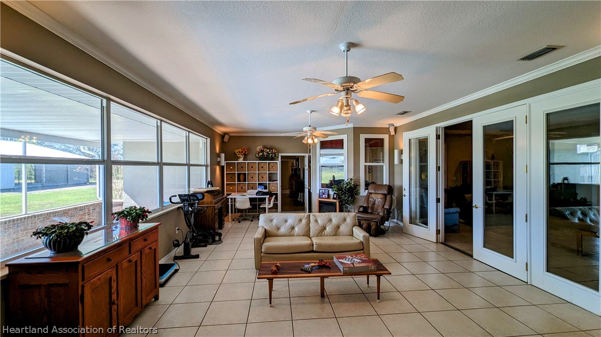 2120 Jack Smith Road Zolfo Springs, FL 33890 - Photo 21 of 36 a living room with patio furniture and a chandelier