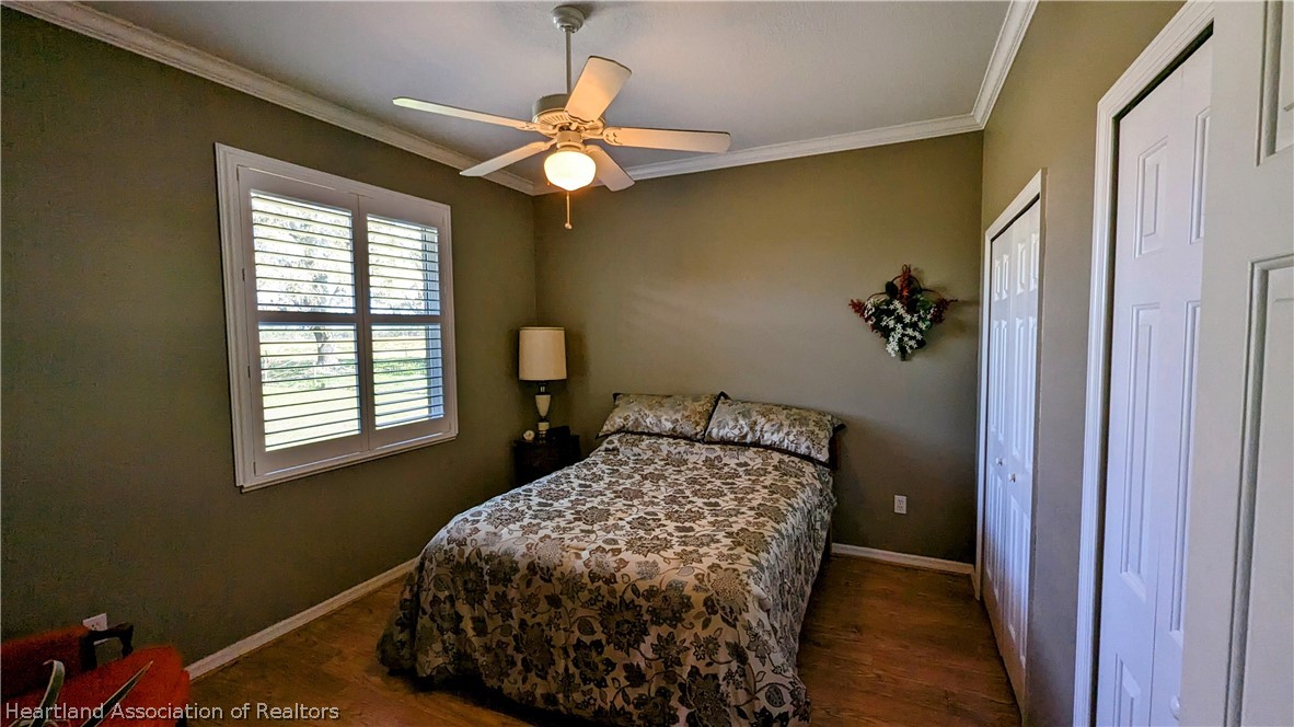 2120 Jack Smith Road Zolfo Springs, FL 33890 - Photo 23 of 36 a bedroom with a bed and a chandelier