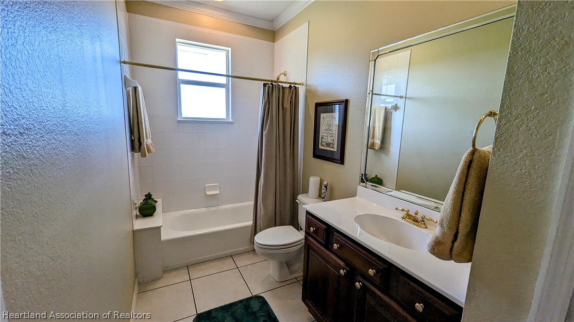 2120 Jack Smith Road Zolfo Springs, FL 33890 - Photo 24 of 36 a bathroom with a sink a toilet a mirror and shower
