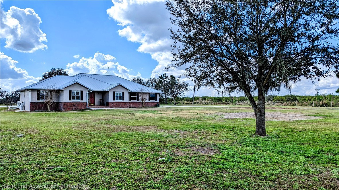 2120 Jack Smith Road Zolfo Springs, FL 33890 - Photo 3 of 36 a view of a house with garden and trees