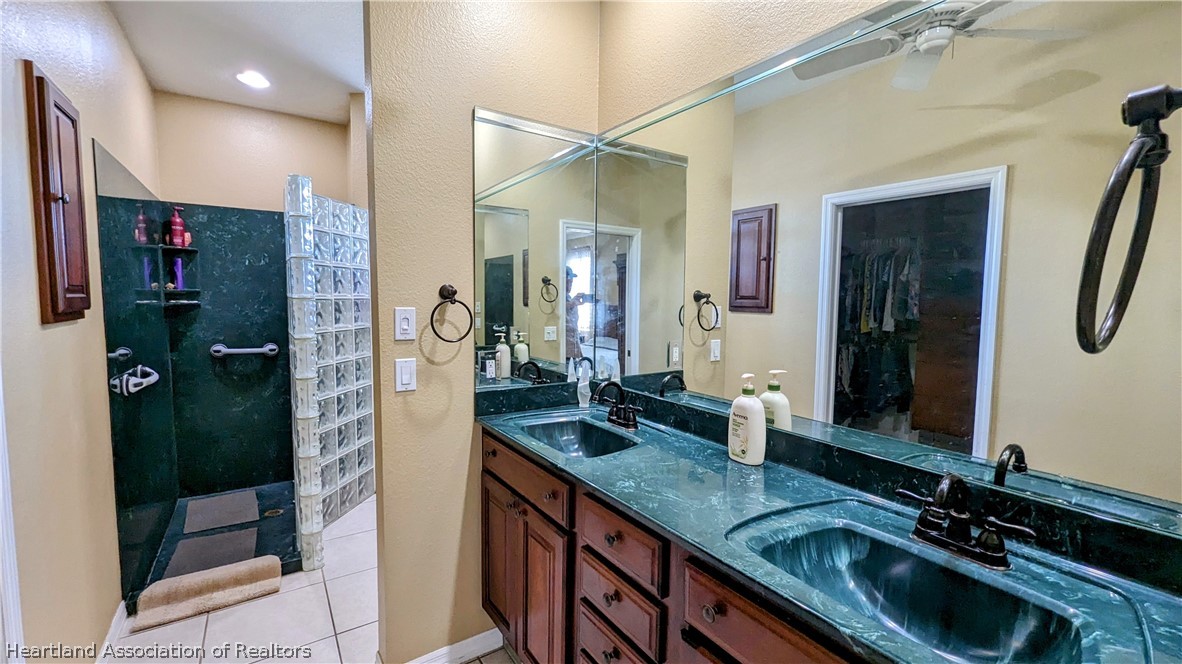 2120 Jack Smith Road Zolfo Springs, FL 33890 - Photo 9 of 36 a bathroom with a granite countertop sink a mirror and shower