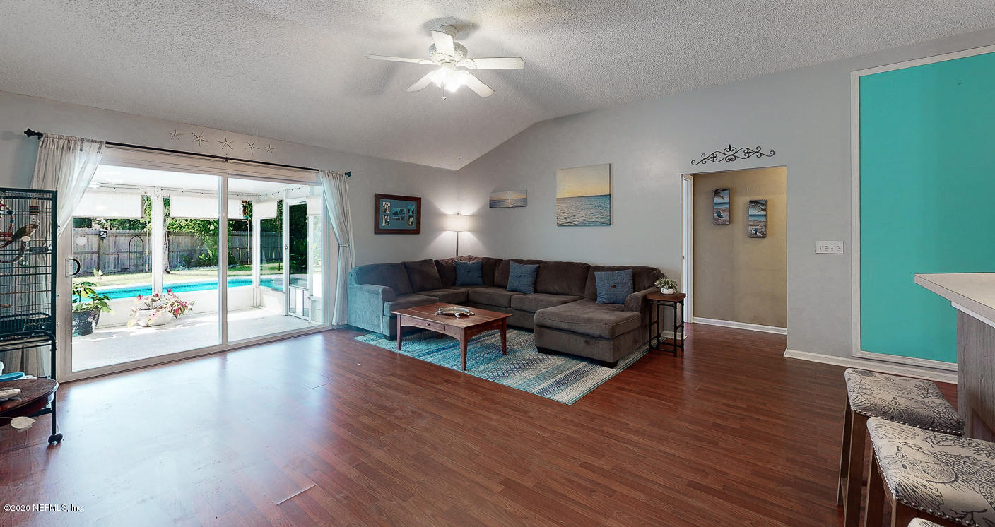 8232 Leafcrest Drive Jacksonville, FL 32244 - Photo 12 of 33 a living room with furniture and a wooden floor