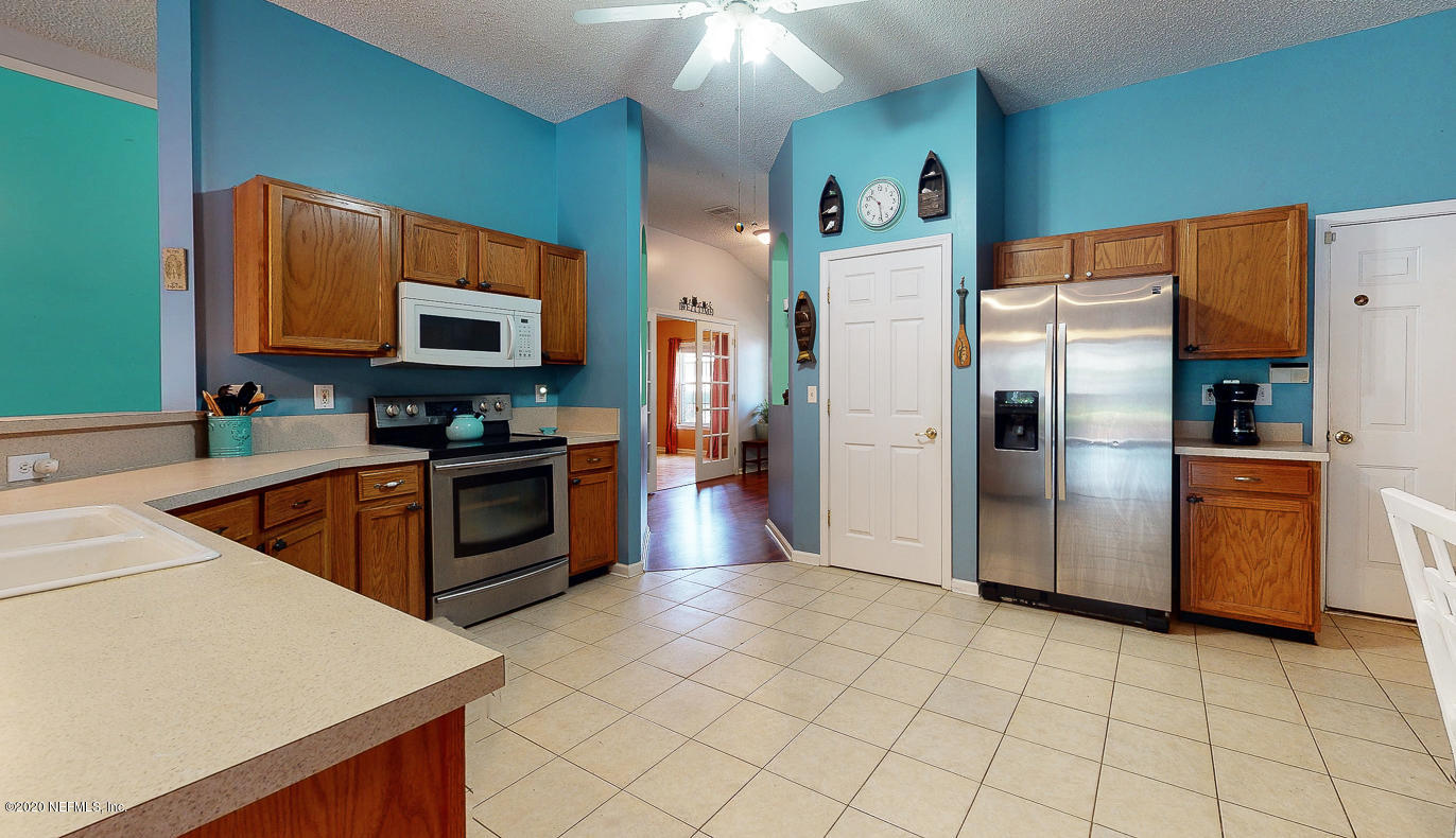 8232 Leafcrest Drive Jacksonville, FL 32244 - Photo 7 of 33 a kitchen with stainless steel appliances a refrigerator a stove a sink a counter top space and cabinets